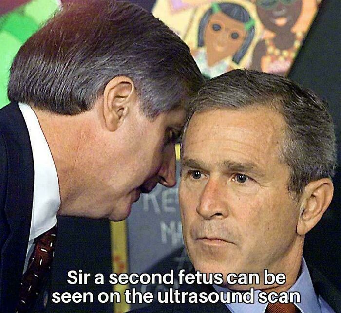 A man whispers to George W. Bush, who looks on with a serious expression. A relatable moment for dads.