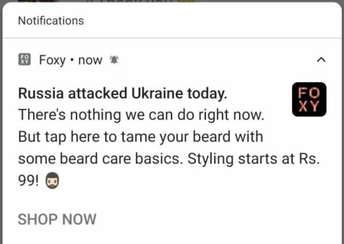 Notification showing an inappropriate advertisement exploiting serious news, an example of design that feels genuinely evil.