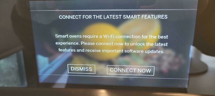 Smart oven screen prompting connection for latest features and software updates, highlighting design that feels genuinely evil.