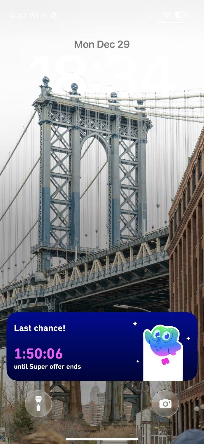 Smartphone lock screen showing a bridge with a pop-up advertisement countdown overlay, illustrating car ads design concept.
