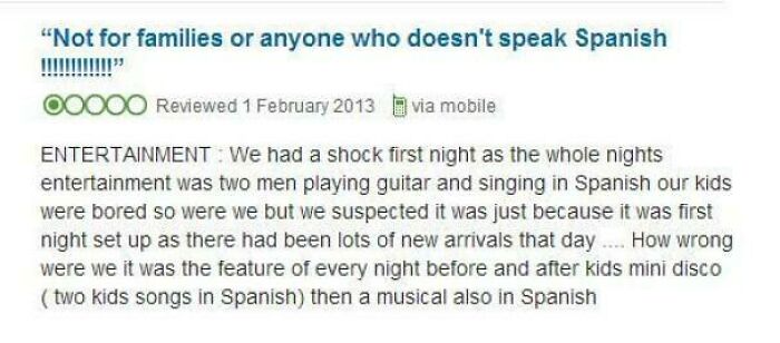 Customer review complaining about entertainment being in Spanish, expressing frustration with language and content choices.