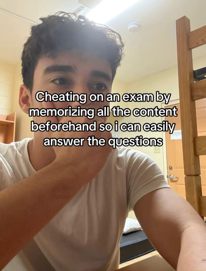 Young man in a dorm room with text about cheating on an exam by memorizing content, relating to life posts and memes.