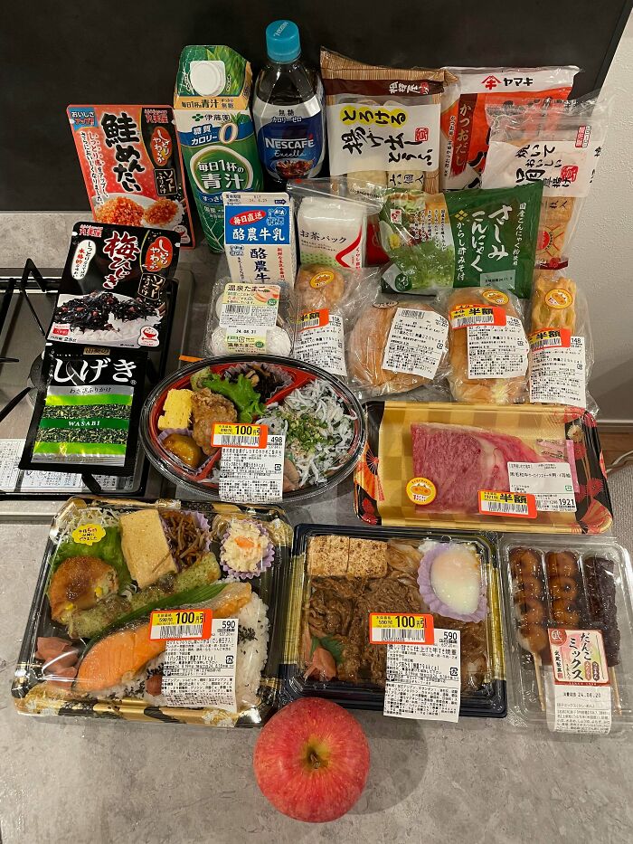 Assorted groceries with price tags and labels showing the cost of food items where they live in Japan.