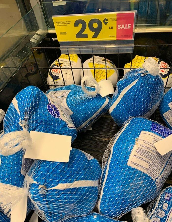 Frozen turkeys displayed in a grocery store with price tag showing 29 cents per pound, highlighting grocery costs.