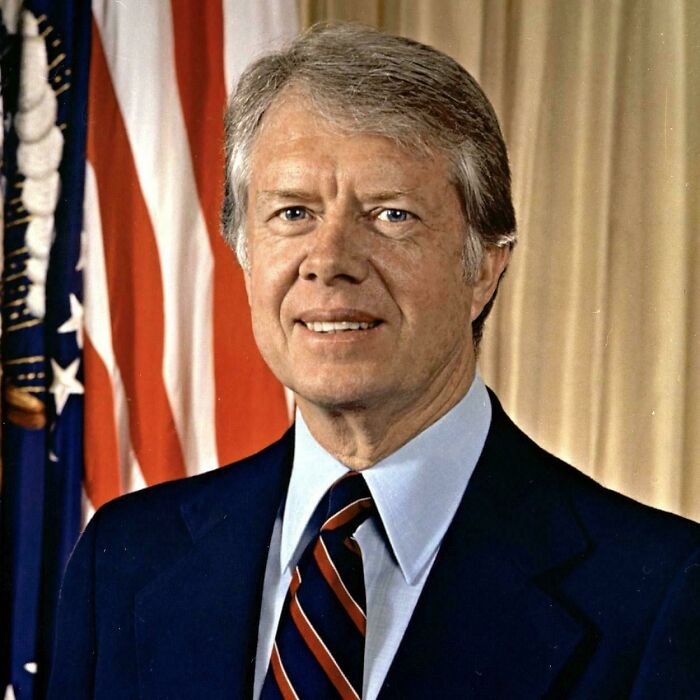 Interesting photo of former President Jimmy Carter smiling in a formal portrait.