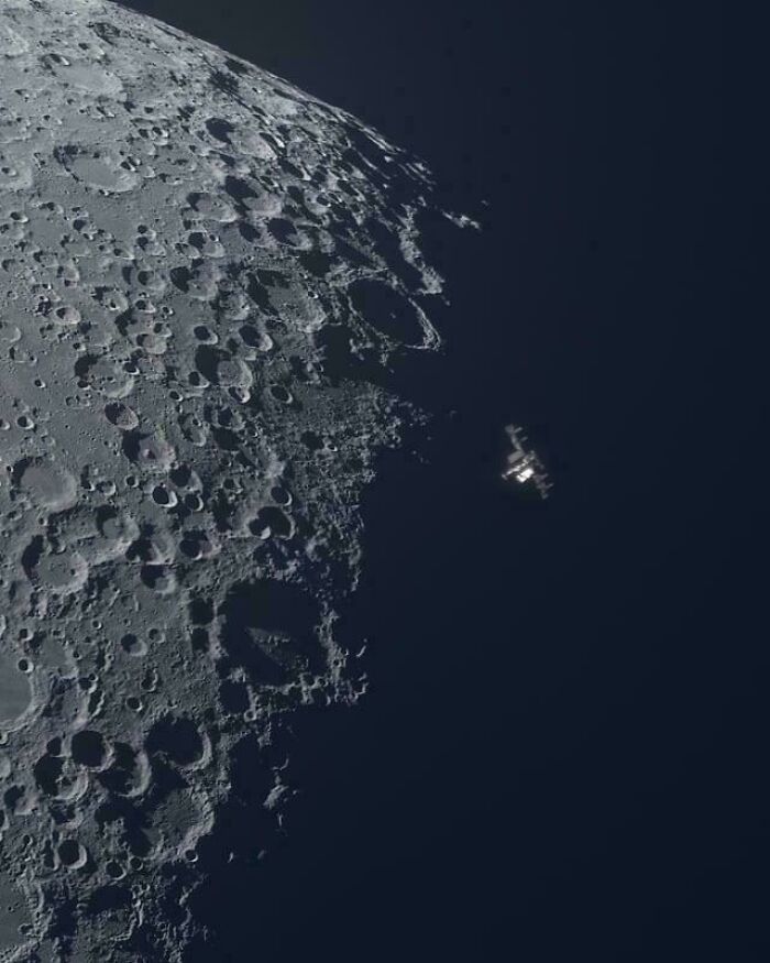An interesting photo of a spacecraft orbiting the moon, showcasing its cratered surface and the vastness of space.