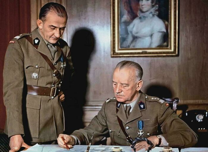Two military men looking at maps, an interesting photo showing strategic planning.