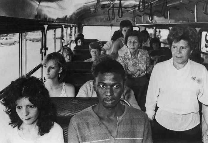 People on a bus, showing a historical moment that is d**n interesting.