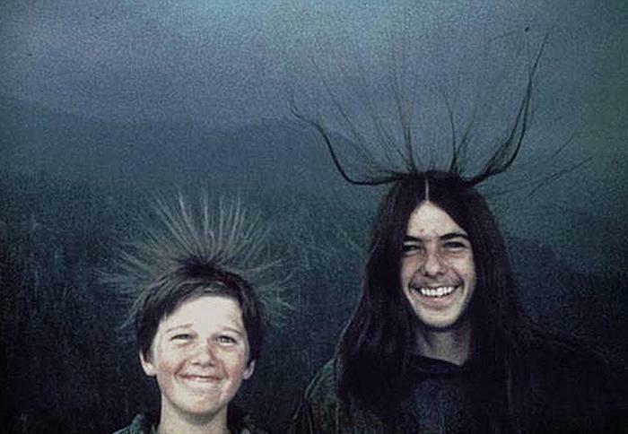 Two happy people with static electricity making their hair stand up, a truly interesting photo.