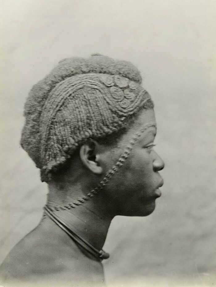 A black and white profile photo of a person with intricately styled hair, saying 'D**n, That's Interesting'.