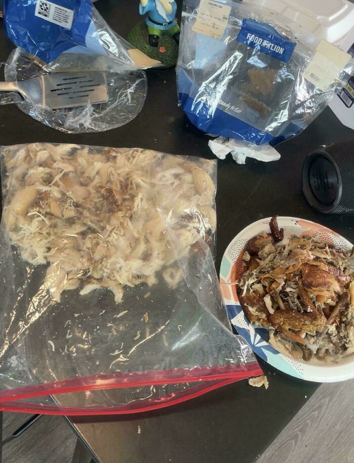 A Ziploc bag of shredded chicken next to a plate of chicken scraps, demonstrating frugal tips for this economy.