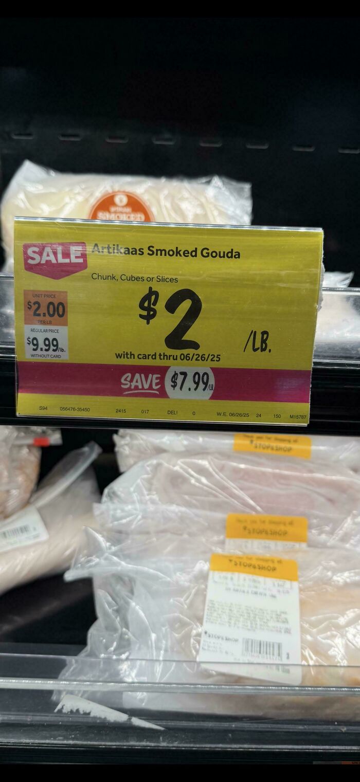 A grocery store shelf with a yellow sale sign for Artikass Smoked Gouda for $2/lb, saving $7.99/lb. This sale offers frugal tips for this economy.
