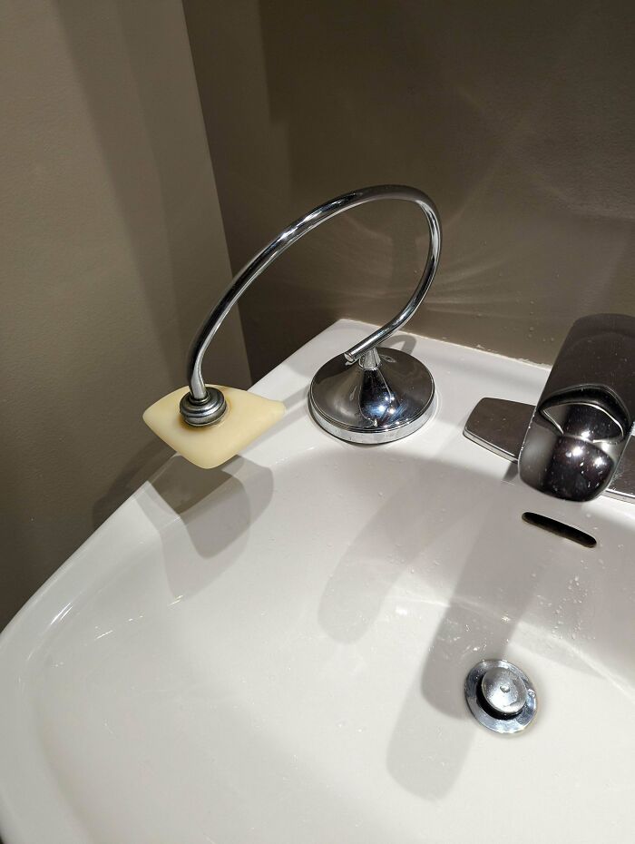 Magnetic soap holder with a bar of soap above a white sink, demonstrating frugal tips for economy.