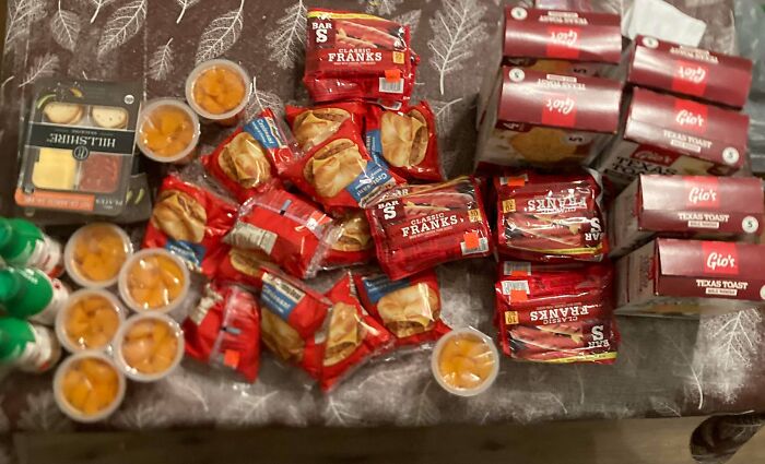 A table full of groceries including hot dogs, mini cheese plates, fruit cups, and Texas Toast. Frugal tips for this economy.