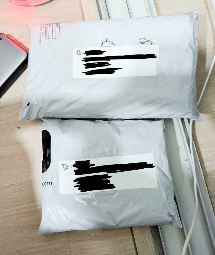 Two white packages with shipping labels on a light wooden floor, representing frugal tips in this economy.