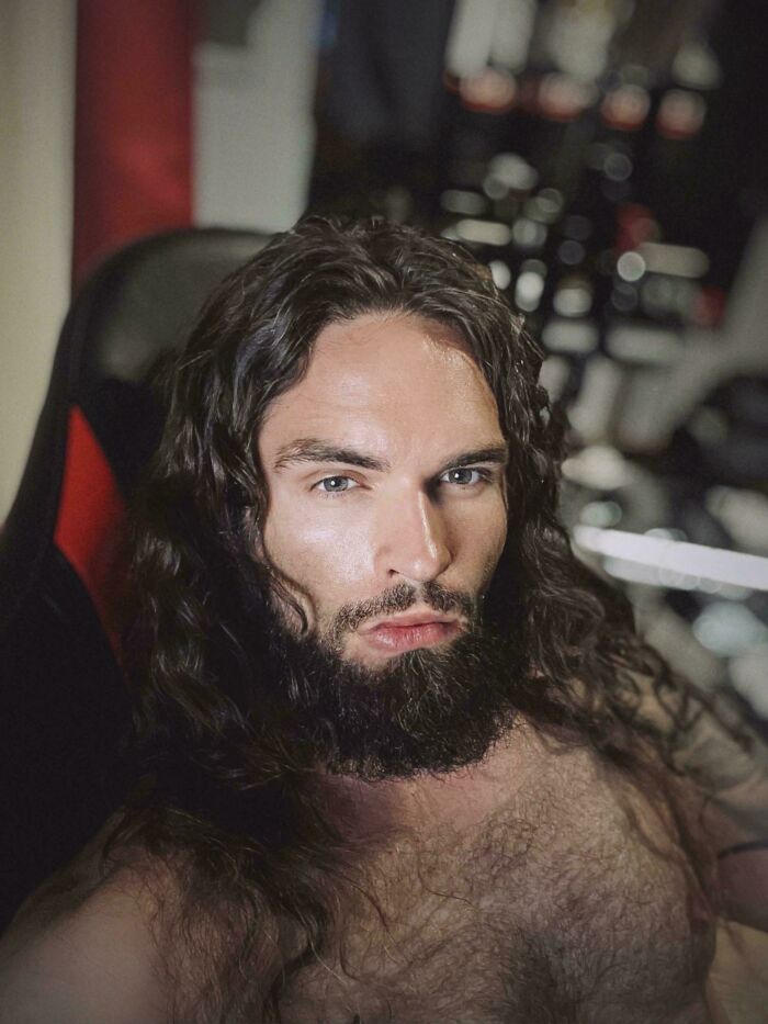 A man with amazing long hair and a beard, looking directly at the camera with intense blue eyes.
