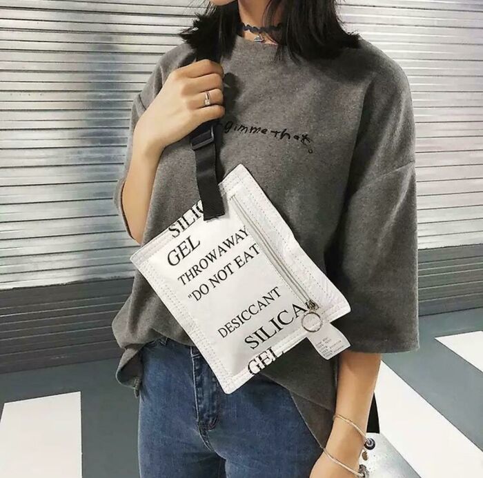 Person wearing a bag resembling a large silica gel packet