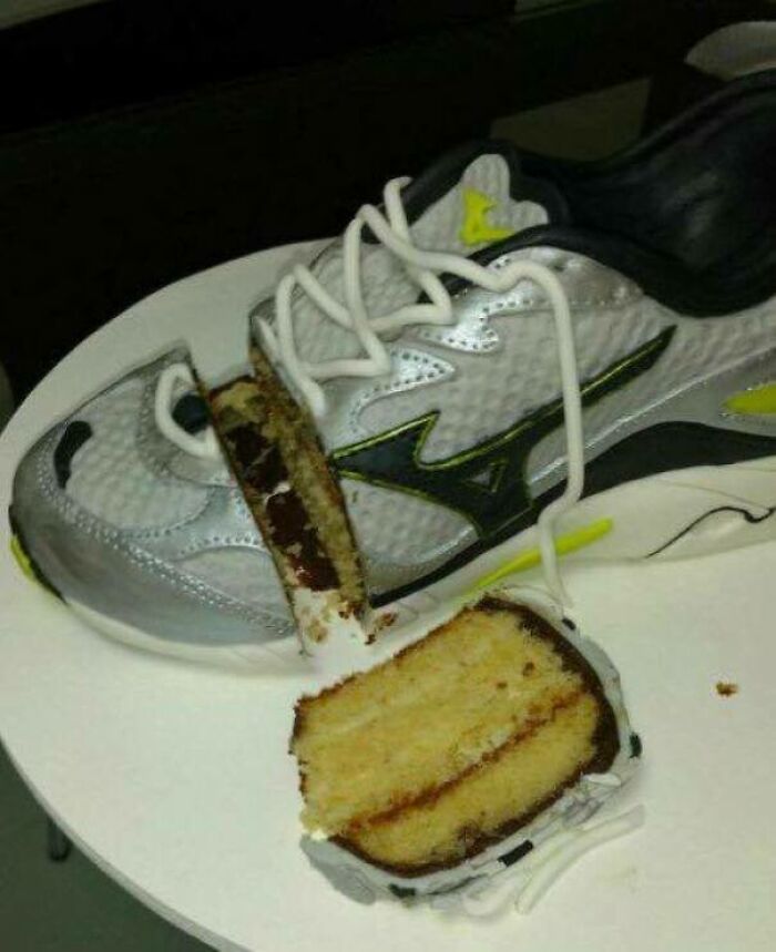 Sneaker with a slice of cake inside it, mixing shoe and food