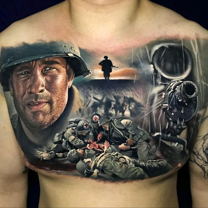 Detailed chest tattoo showing a war scene with soldiers and weapon