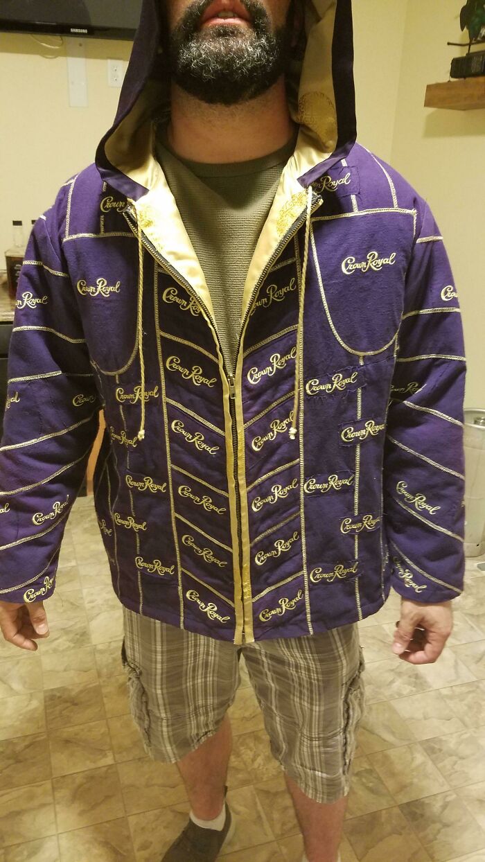 Man wearing a hoodie jacket covered in Crown Royal logos