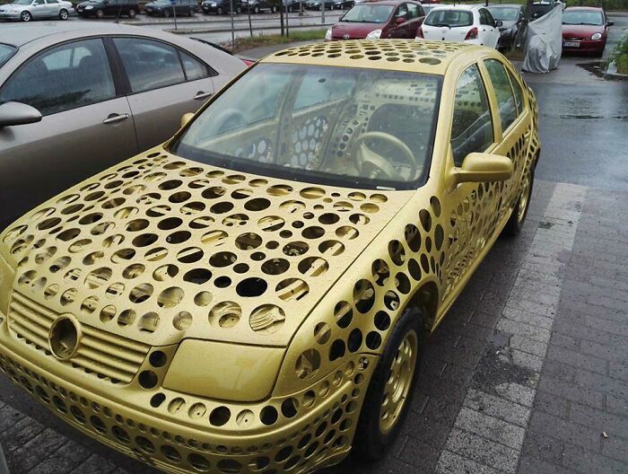 Gold car covered in holes revealing unique and unhinged craftsmanship concept