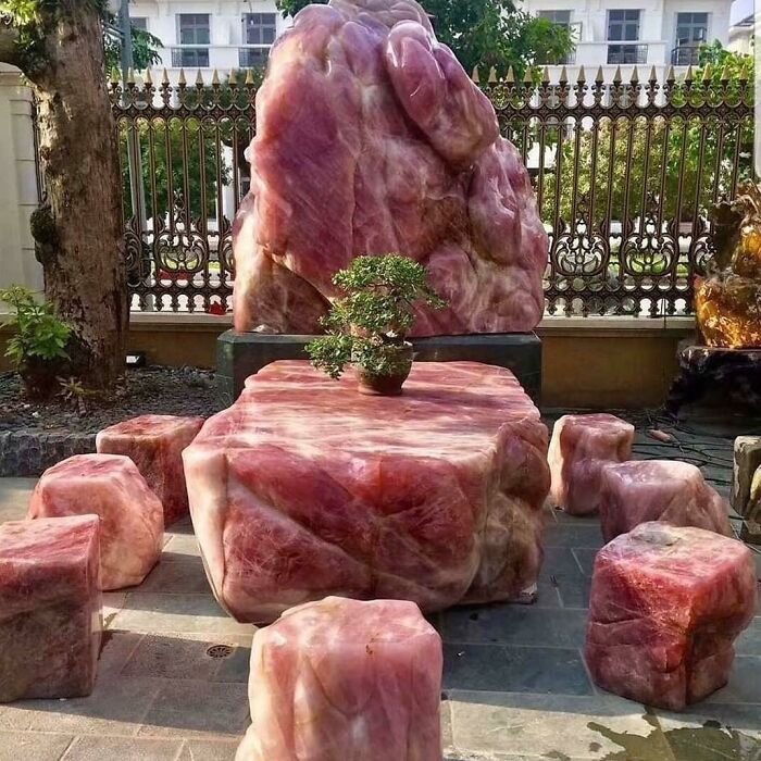 Outdoor table set carved from pink marble stone with matching cube seats