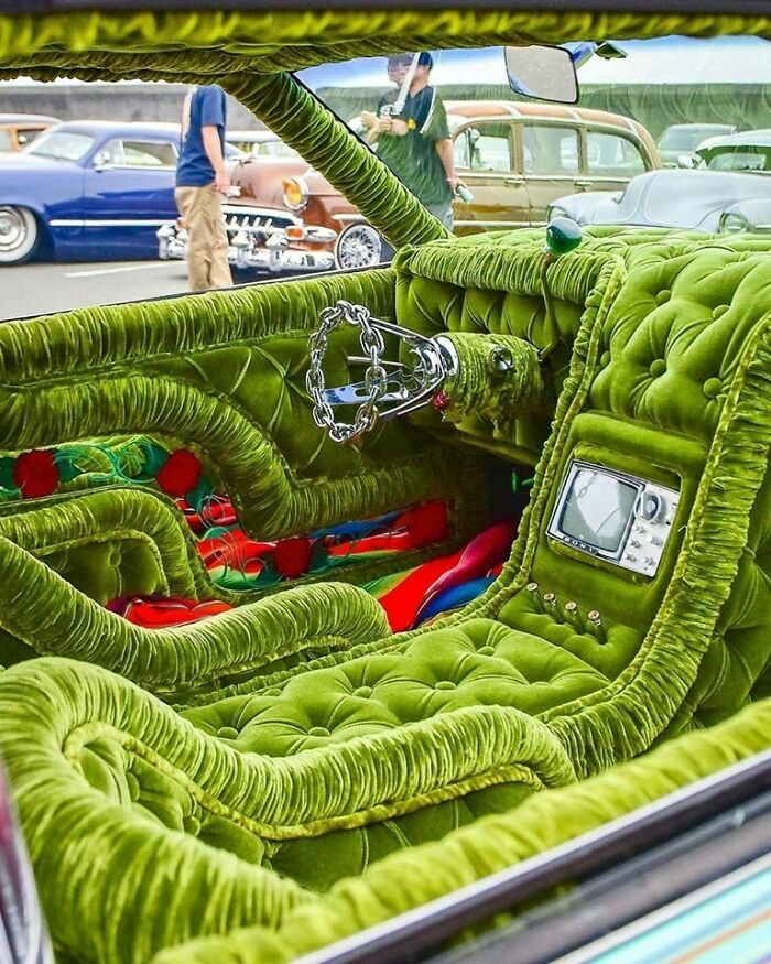 Car interior fully upholstered in green velvet fabric with classic car features