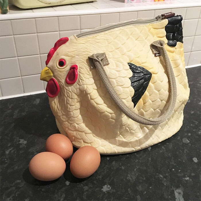 Realistic chicken-shaped handbag with detailed scales and eggs illustrating unique craftsmanship