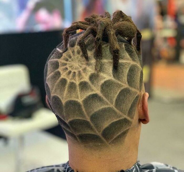 Intricate spider web hair design with realistic fake spider showing flawless craftsmanship