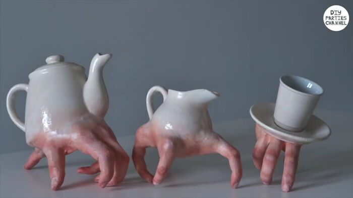 Unique ceramic tea set designed with realistic human fingers as legs