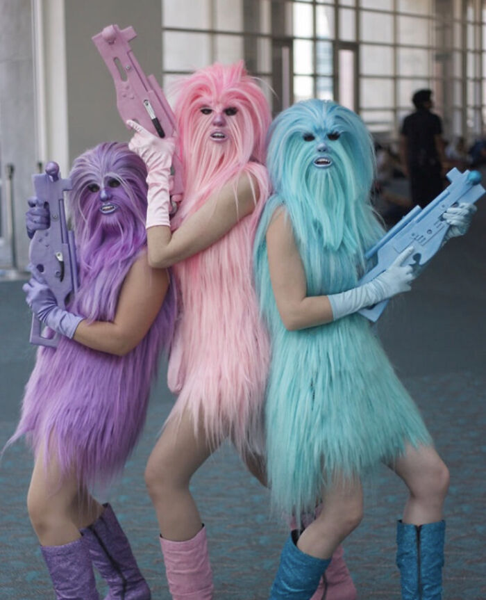 Unhinged costumes with colorful furry creatures holding toy weapons