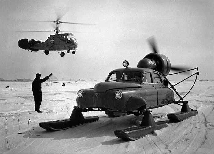 Vintage black and white photo of retro car adapted with helicopter blades on skis