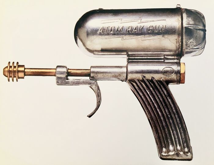 Retrofuturism classic toy atom ray gun with metallic silver and gold finish