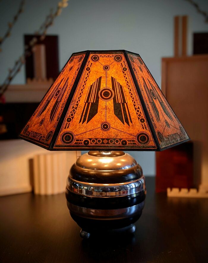 Retro styled geometric lamp with glowing amber panels and futuristic designs