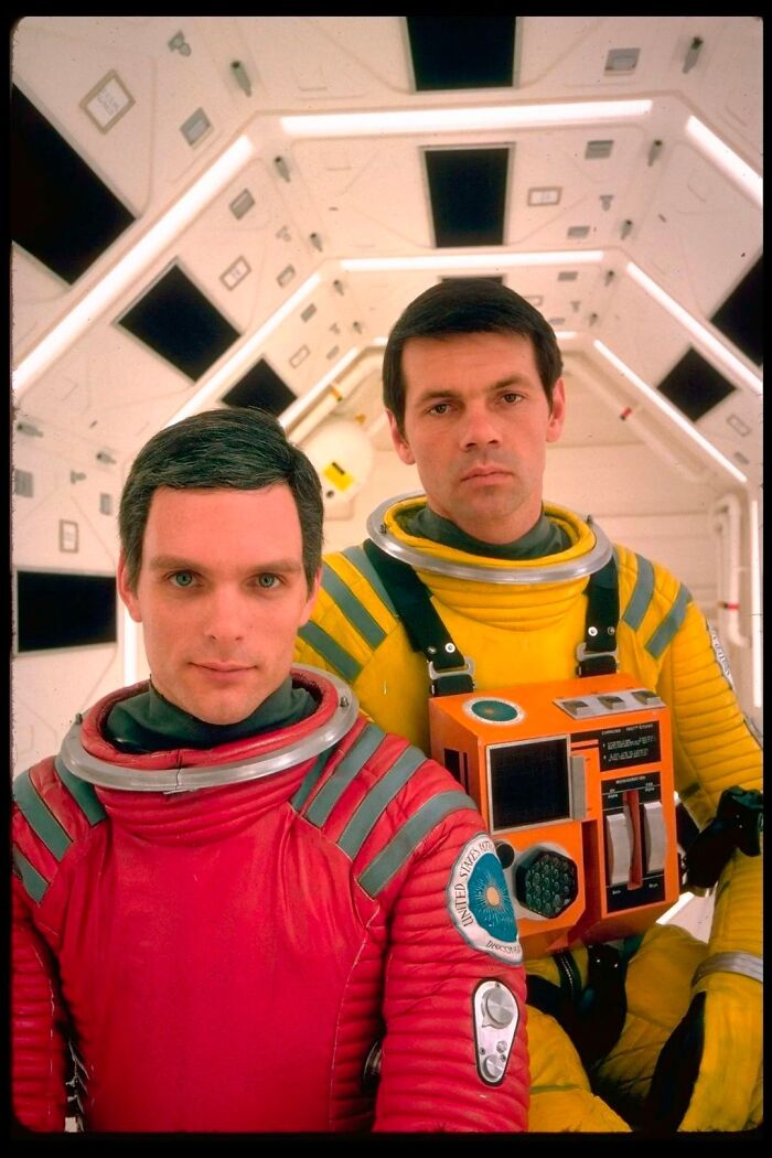 Retrofuturism space suit costumes with vintage design inside futuristic spacecraft