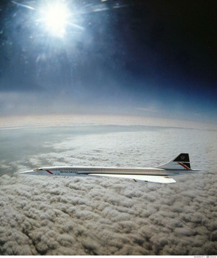 Retrofuturism supersonic British Airways plane flying above clouds against the sun