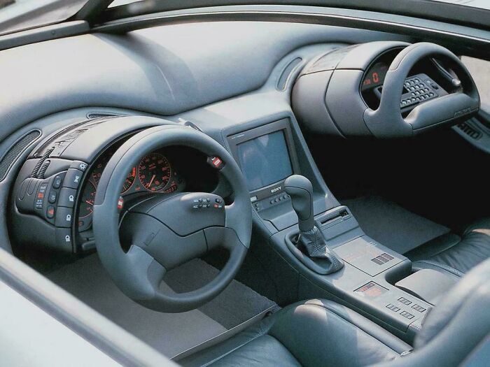Retrofuturism car interior with futuristic dual steering wheels and integrated screen controls