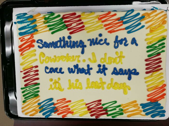 Cake with colorful icing border and a humorous misprint showing failed understanding of instructions.