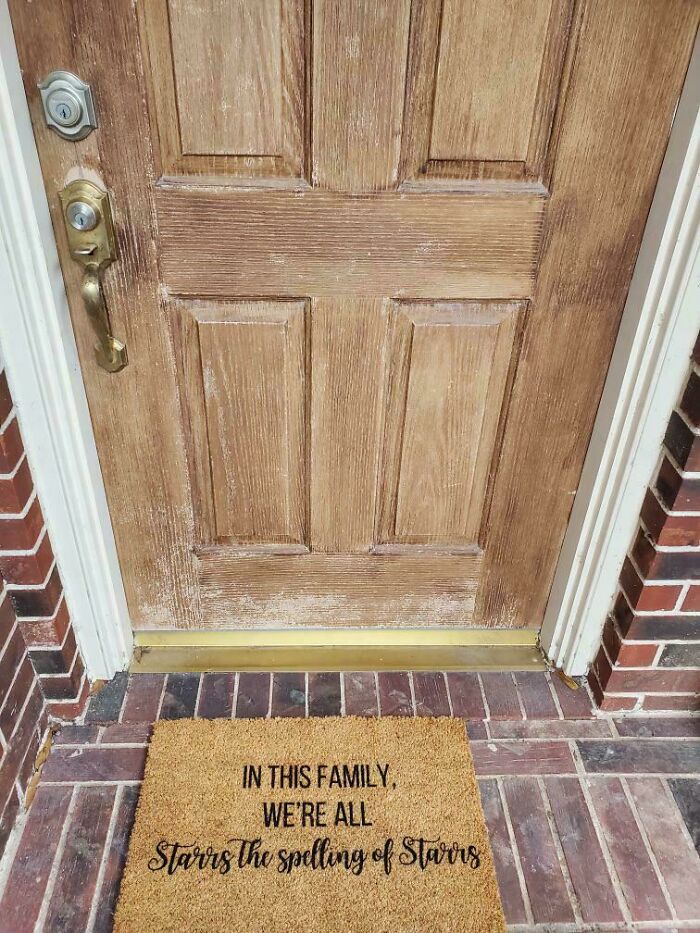 Doormat with a humorous misprint showing a family misunderstanding spelling instructions on a front porch.