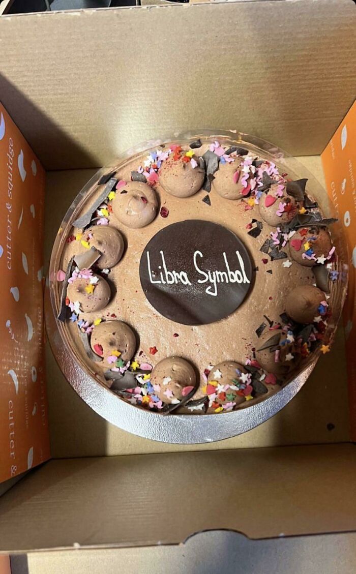 Chocolate cake with colorful sprinkles and the misprint "Libra Symbol" instead of the requested design, showcasing hilarious misprints.