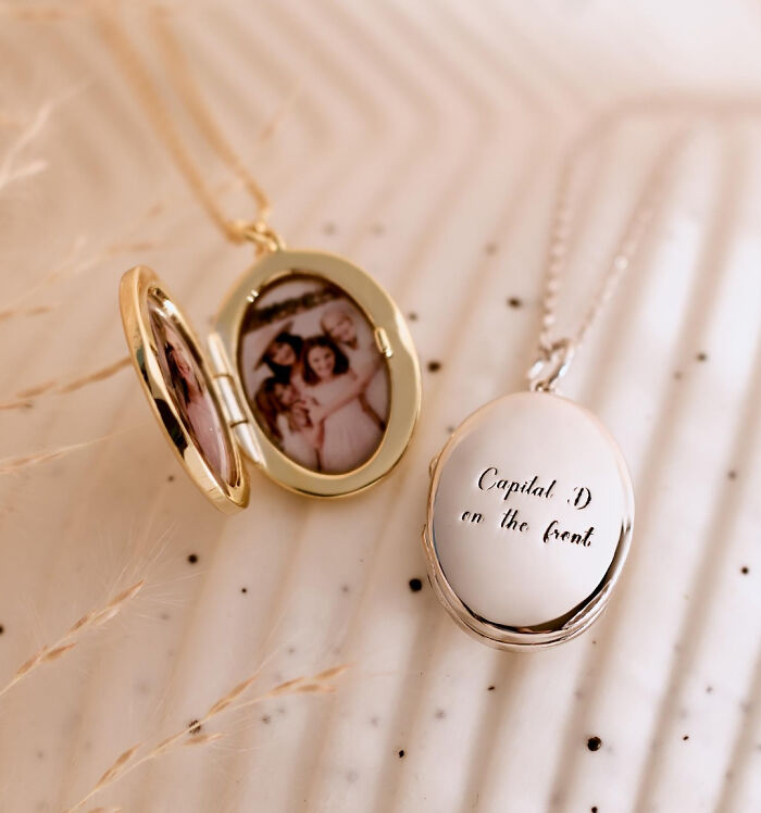 Gold and silver lockets showing a family photo and a hilarious misprint with failed instructions on the cover.