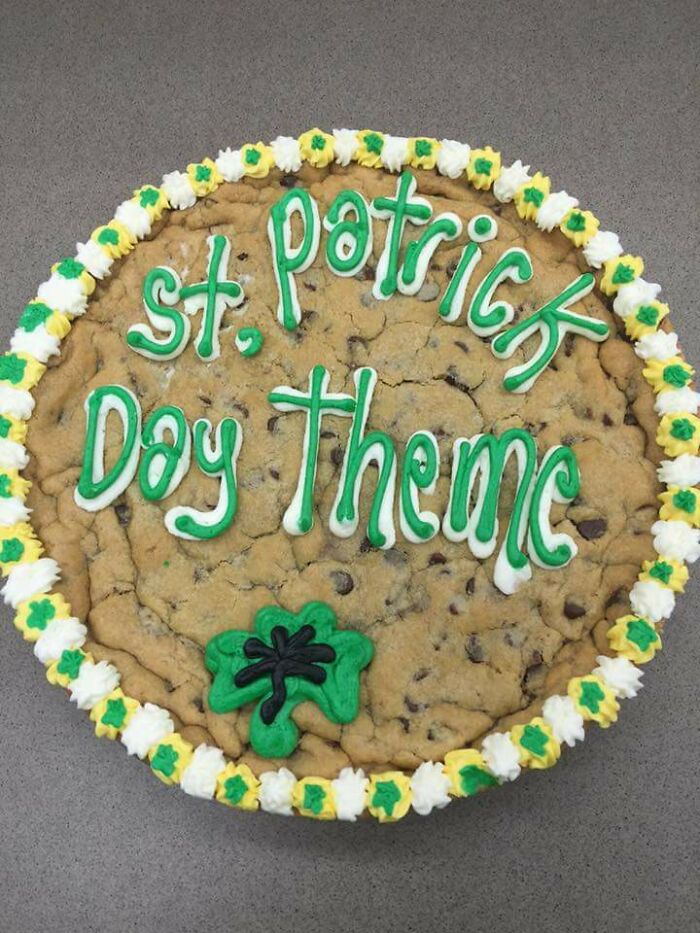 Large cookie cake with green and white icing spelling out a hilarious misprint of St. Patrick Day theme in green letters.