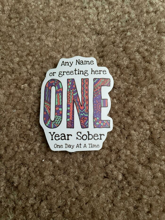 Sticker that mistakenly says Any Name or greeting here one year sober instead of a customized message, a hilarious misprint fail.
