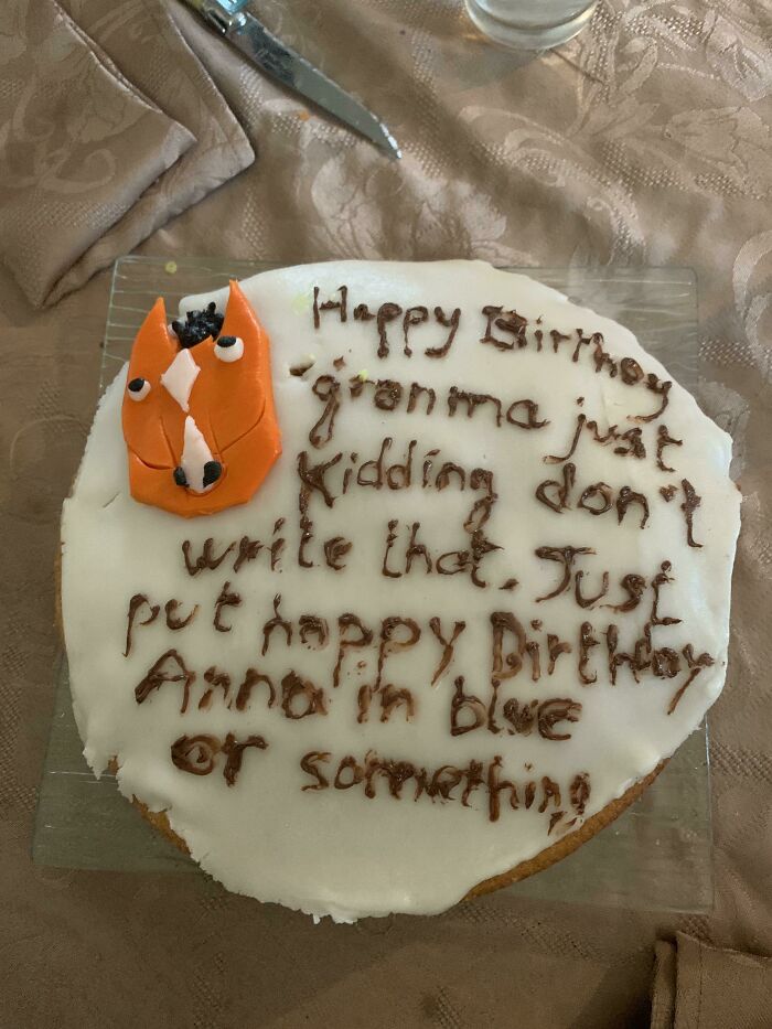 Cake with funny misprint text failing to understand instructions, featuring a fox decoration and messy handwriting.