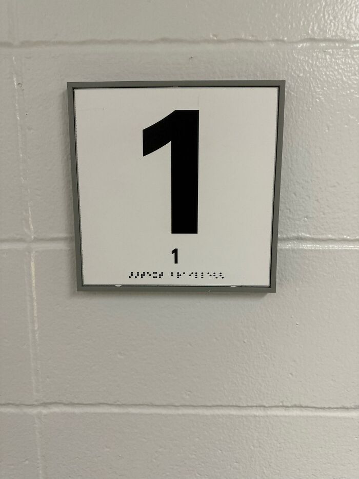 Room number sign showing number 1 with braille that fails to match instructions for accessibility guidelines.