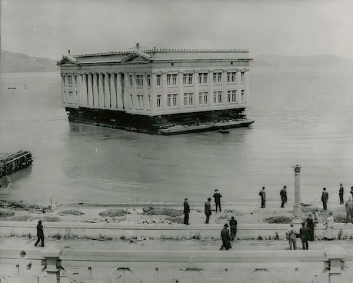 Historic building being transported on water, showcasing unique architecture among interesting buildings lost as the world changed.