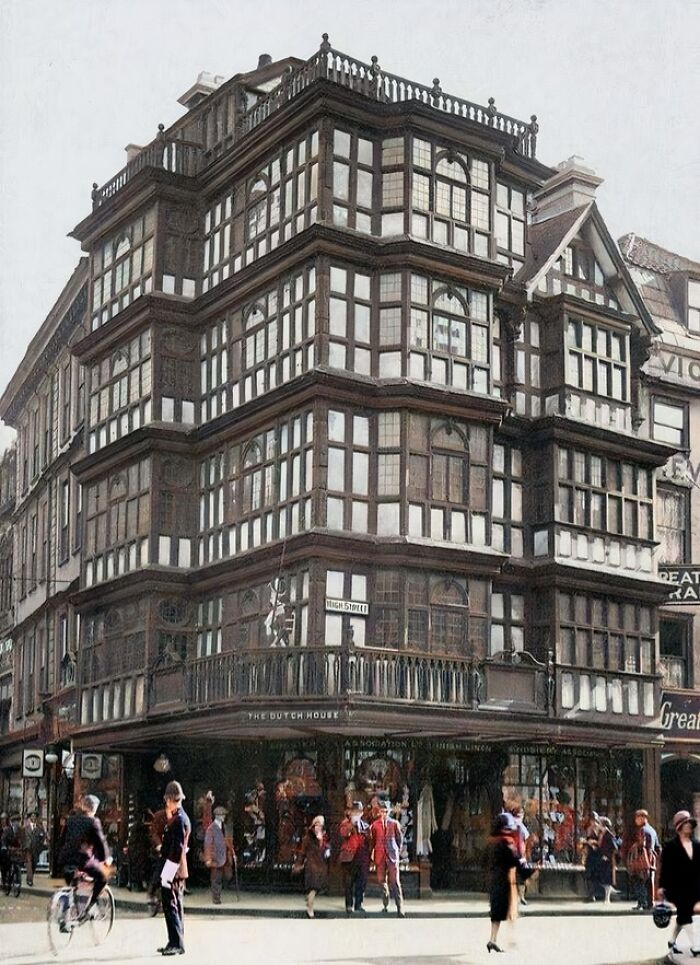 Historic timber-framed building with detailed windows and busy street scene, showcasing interesting buildings lost over time.