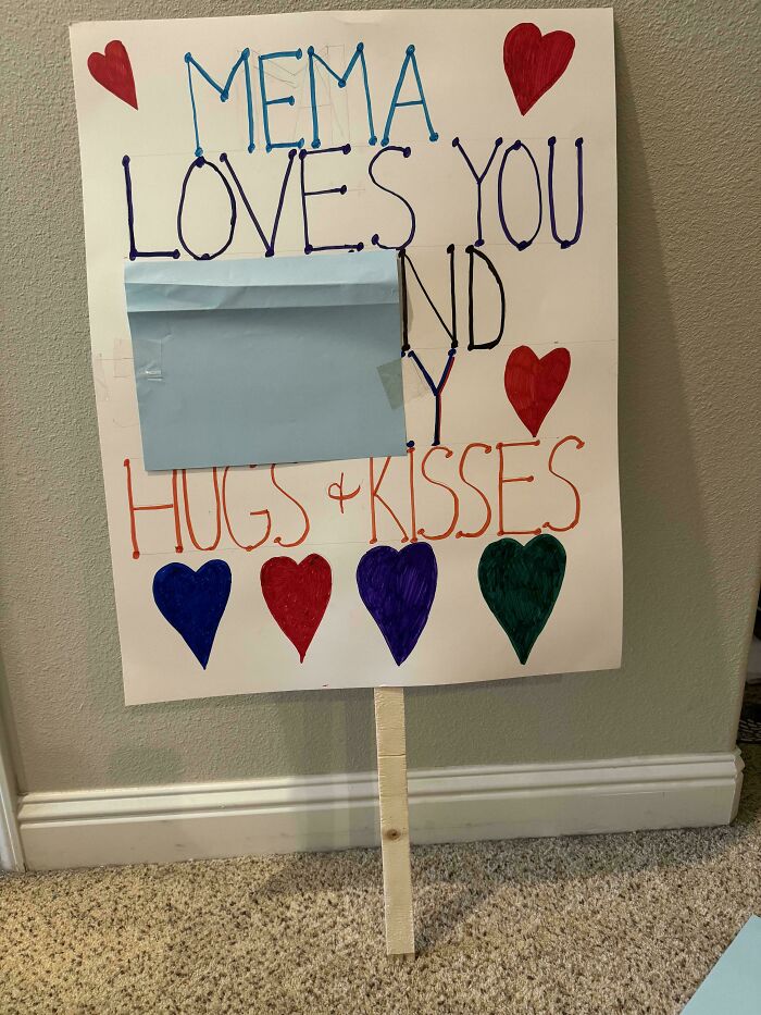 Handmade sign with hearts saying Mema loves you and hugs and kisses, showing entitled family member message.