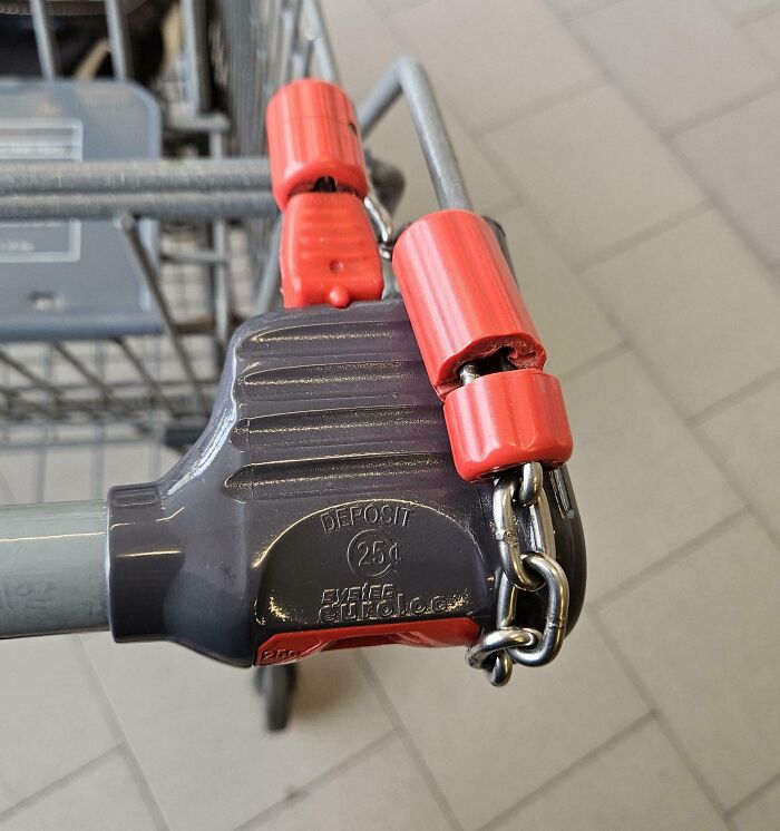 Shopping cart lock held in place with red plastic clips and chain, illustrating creativity of lazy people.