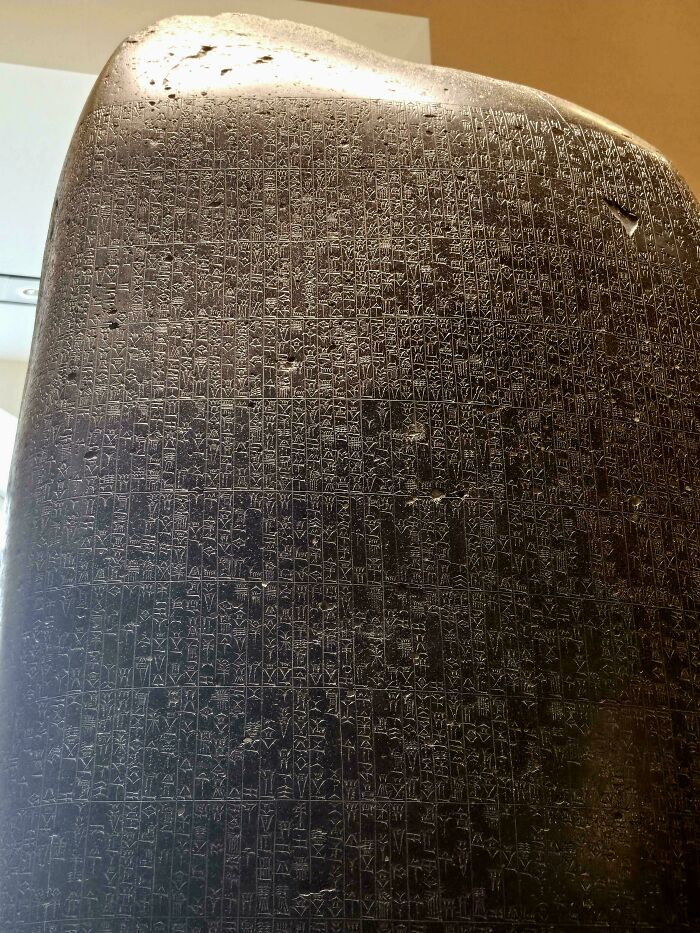 Ancient black stone tablet with engraved cuneiform writing, an antique item preserving historical secrets.